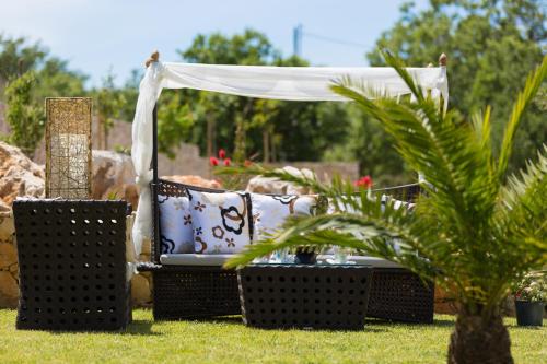 a gazebo with a couch in the grass at Villa Victoria in Gállos