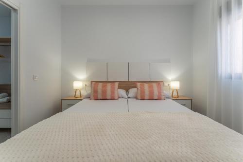 a bedroom with a large bed with two pillows at CMDreams Platinium- Apartamentos turísticos en el centro de Mérida in Merida
