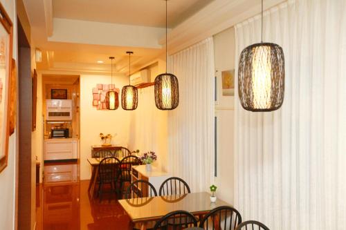 a kitchen and dining room with a table and chairs at Nature House Homestay in Dongshan