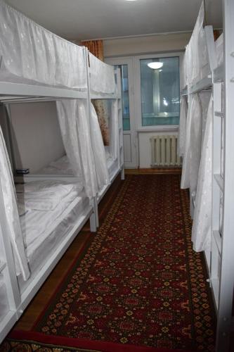 a room with two bunk beds and a carpet at Camel Track Guesthouse and Tour Operator LLC in Ulaanbaatar
