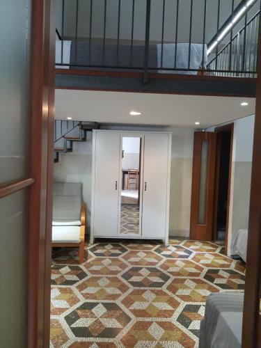 a room with a staircase and a carpeted floor at Albergo Avalon in Turin