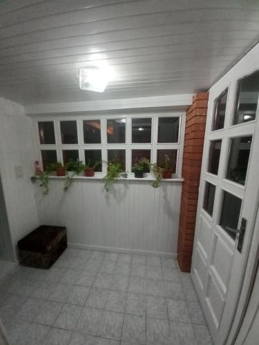 a garage with potted plants on a window ledge at Soba Dujaković in Banja Vrućica