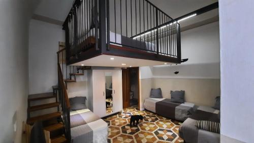 a living room with two beds and a staircase at Albergo Avalon in Turin