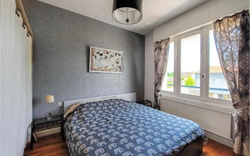 um quarto com uma cama azul e uma janela em appartement t3 terrasse em Troyes