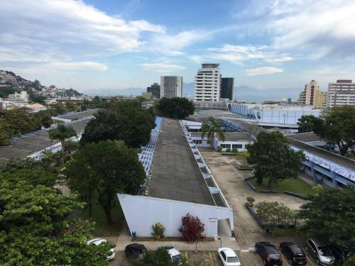 a view of a city with cars parked in a parking lot at Não é studio, apto espaçoso 70m, 2 quartos, sacada fechada, garagem e bem no centro in Florianópolis