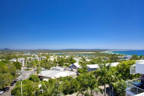 an aerial view of a resort with palm trees and the ocean at Bali Hai Apartments Noosa in Noosa Heads