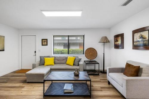 a living room with a couch and a table at Harbourside Flats in Fort Lauderdale