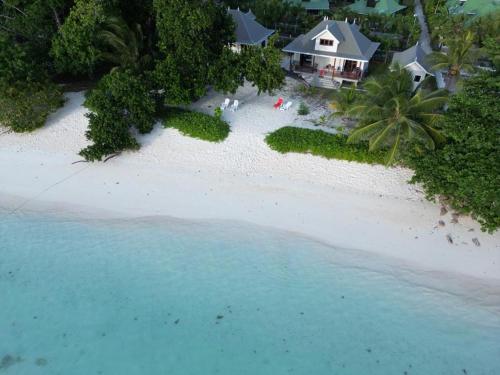 an aerial view of a house on a beach at Digwa Beach Chalet in La Digue