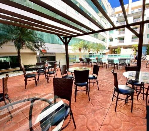 an outdoor patio with tables and chairs and tables and chairs at Apto Summer Beach, ensolarado e aconchegante in Bombinhas