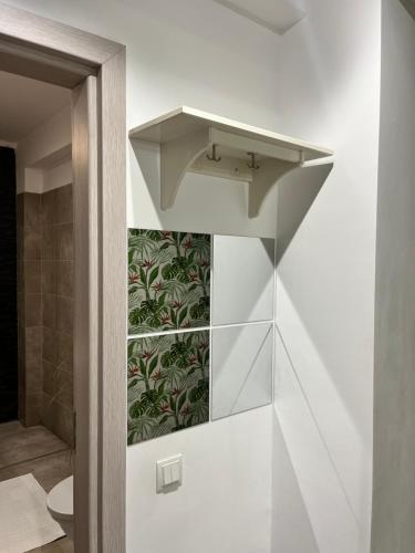a shelf in a bathroom with a sink at Green Divine Apartament in Popeşti-Leordeni