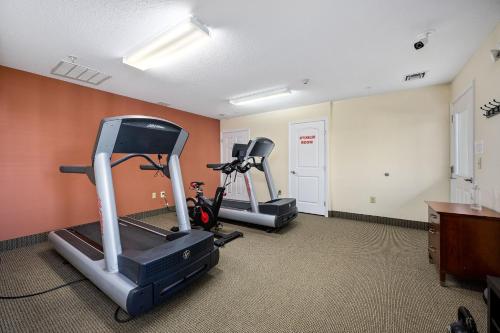 a gym with two tread machines in a room at Affordable Suites of America Stafford Quantico in Stafford