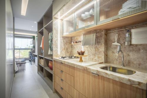 a kitchen with a sink and a counter top at Eco Resort Praia dos Carneiros Apt Luxo Beira Mar in Tamandaré