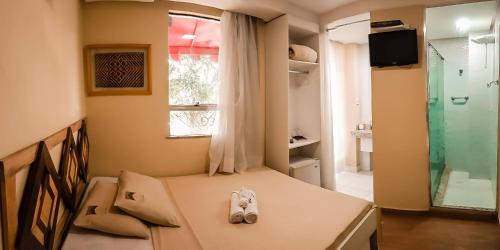 a pair of shoes sitting on a bed in a room at Boutique Hotel Casa Teatro in Manaus