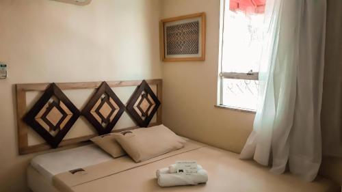 a small bedroom with a bed with a window at Boutique Hotel Casa Teatro in Manaus