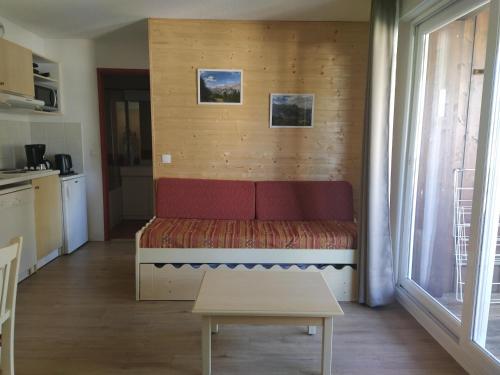 a bedroom with a bed and a table in a room at les chalets de puy st vincent in Puy-Saint-Vincent