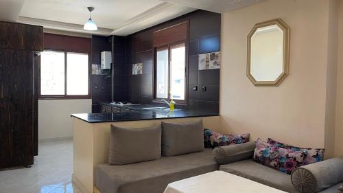 sala de estar con sofá y cocina en Appartement au coeur d'Aourir, en Aourir