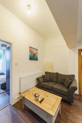 a living room with a couch and a coffee table at Augusta lodge Moseley in Birmingham