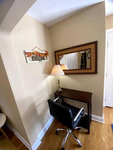 a desk and a chair in a room with a mirror at Cozy Boston Getaway Apartment! Free Parking in Boston