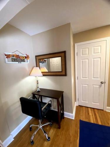 a room with a desk and a chair and a mirror at Cozy Boston Getaway Apartment! Free Parking in Boston