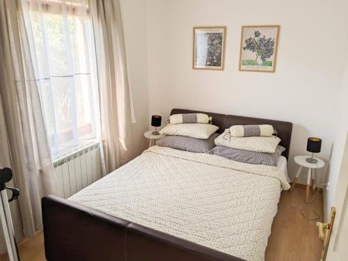 a bedroom with a bed with two pillows on it at Duplex House in Bijeljina