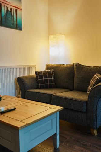 a living room with a couch and a coffee table at Augusta lodge Moseley in Birmingham
