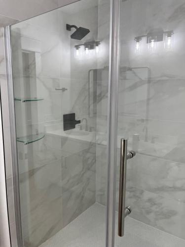 a shower with a glass door in a bathroom at The Clifford House in Pensacola