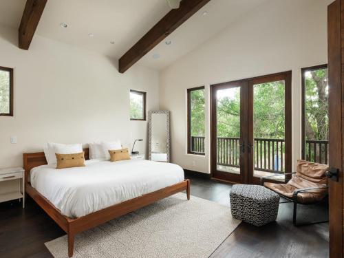 a bedroom with a bed and a balcony with windows at Private Resort in Lake Hodges in Escondido