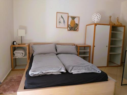 a large bed in a room with two shelves at Waldwinkel in Treuchtlingen