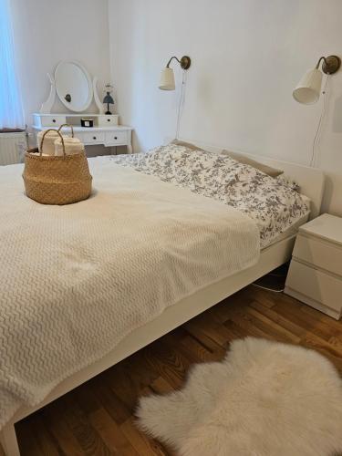 a bedroom with a bed with a rug and two lamps at The Garden Nook in Zagreb
