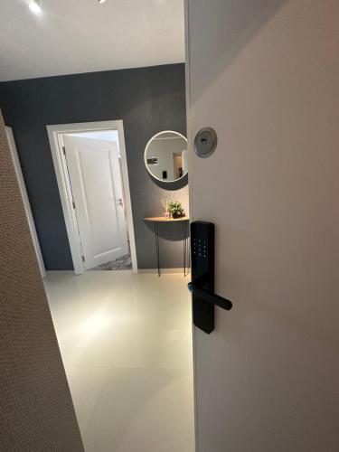 a door leading into a room with a mirror at Complex Rediu 54 Luxury Apartaments in Iaşi