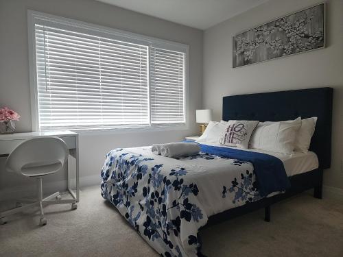 a bedroom with a bed and a desk and a window at Dorothy's Place in Ottawa