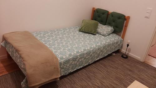 a bed with two pillows on it in a room at Stockholm Private Rooms in Shared Lovely, Amazing, Modern Apartment +Garden +BBQ in Stockholm