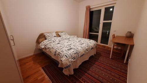a small bedroom with a bed and a window at Stockholm Private Rooms in Shared Lovely, Amazing, Modern Apartment +Garden +BBQ in Stockholm