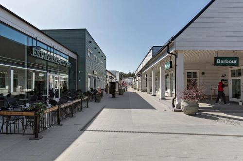 a street in a town with tables and chairs at Stockholm Private Rooms in Shared Lovely, Amazing, Modern Apartment +Garden +BBQ in Stockholm