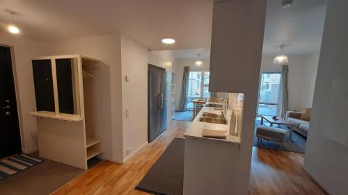 a room with a kitchen and a living room at Stockholm Private Rooms in Shared Lovely, Amazing, Modern Apartment +Garden +BBQ in Stockholm
