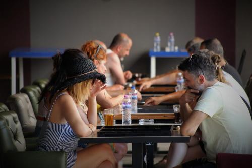 a group of people sitting at a table at Manuela Boutique Hotel Bitez in Bitez