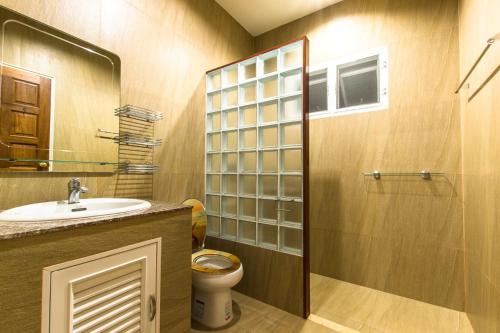 a bathroom with a toilet and a sink and a shower at Chaba Pool Villa in Nai Harn Beach