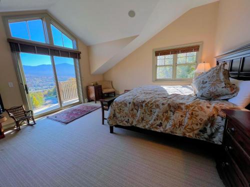 a bedroom with a bed and a large window at Presidential View Ski-in Ski-out Townhome with Amazing Views in Bretton Woods