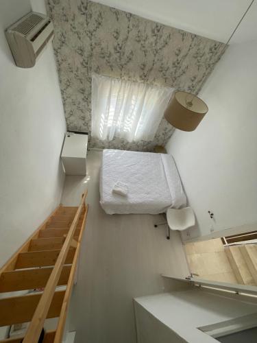 a small room with a bunk bed and a staircase at MEDITERRANEAN HOUSE - Habitaciones Privadas en Casa Compartida in Mairena del Aljarafe