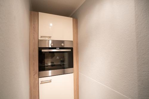 a kitchen with a stainless steel oven in a wall at TONI Charming Apartment in Dresden im ruhigen, grünen Altbauviertel in Dresden