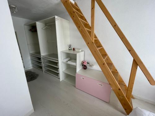 a room with a staircase and a pink cabinet at MEDITERRANEAN HOUSE - Habitaciones Privadas en Casa Compartida in Mairena del Aljarafe