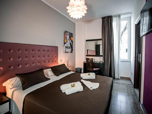 a bedroom with a large bed with towels on it at Casa Celestina in Rome