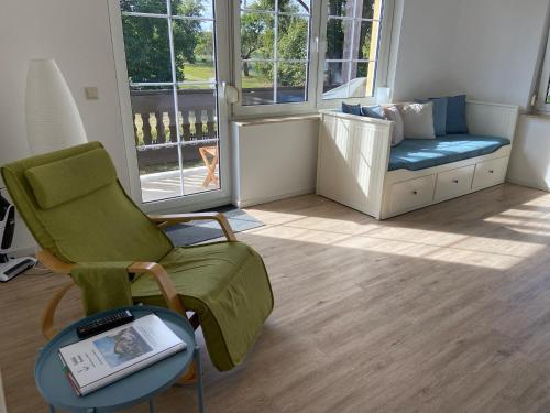 a living room with a chair and a couch at Seeblick Apartments Mühlau in Mühlau