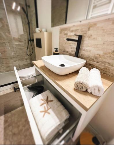 a bathroom with a sink and a counter with towels at Studio Sea View - Royal Ascot in Ostend