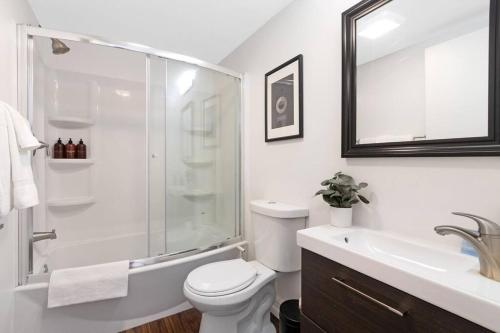 a bathroom with a shower and a toilet and a sink at The Lofts on Clematis 204 Downtown West Palm Beach in West Palm Beach