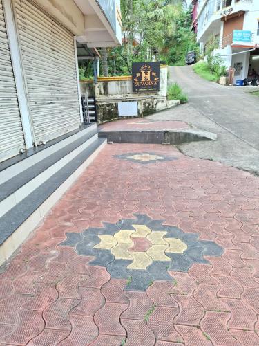 a sidewalk with a star pattern on it next to a building at Suvarna Grande Homes in Mangalore