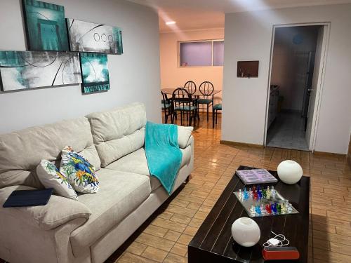 a living room with a couch and a table at Hermoso Depto Vista al Valle in Rancagua