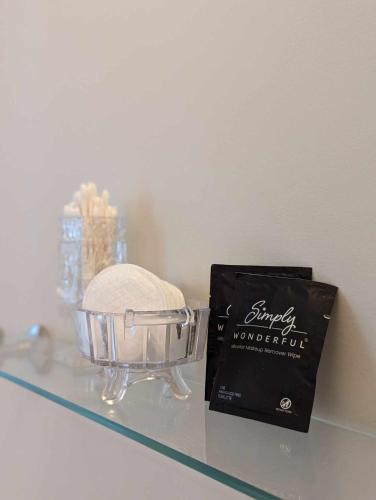 a book next to a glass bowl on a glass shelf at The Vistula Rose B & B in Toledo