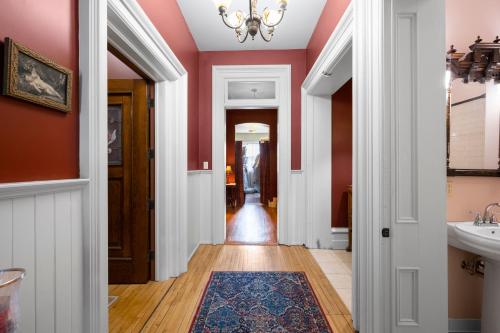 a hallway of a home with red walls and a sink at The Vistula Rose B & B in Toledo