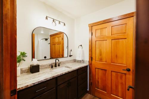 a bathroom with a sink and a mirror at Big Mountain Suite wIn-unit Washer and Dryer in Kalispell